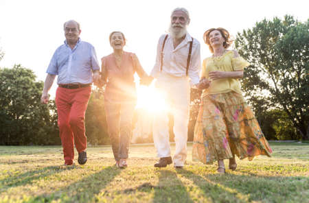 Group of seniors making a picnic at the park and having fun.の写真素材