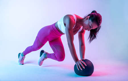Woman training with the exercizes ball in the gymの写真素材