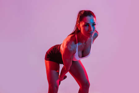 Woman training with dumbbells in the gymの写真素材