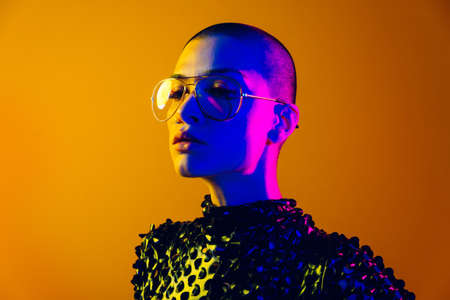Fashion portrait of beautiful woman on colored background