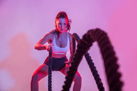 Athletic woman with fitness sportswear traning - Beautiful girl doing fitness in a studio