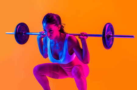 Athletic woman with fitness sportswear traning - Beautiful girl doing fitness in a studioの写真素材