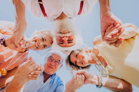 Group of youthful seniors having fun outdoors - Four pensioners bonding outdoors, concepts about lifestyle and elderlyの写真素材