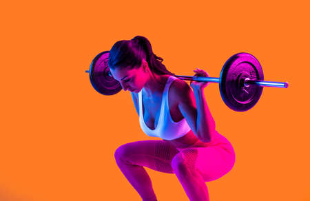 Athletic woman with fitness sportswear traning - Beautiful girl doing fitness in a studio
