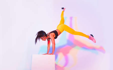 Athletic woman with fitness sportswear traning - Beautiful girl doing fitness in a studioの写真素材