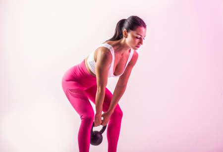 Athletic woman with fitness sportswear traning - Beautiful girl doing fitness in a studioの写真素材