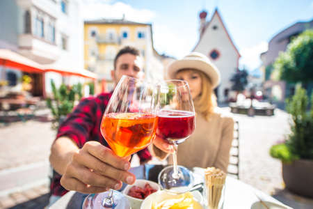 Happy couple taking an aperitif in a cafÃ¨. Man and woman on their honeymoon travel on the italian...