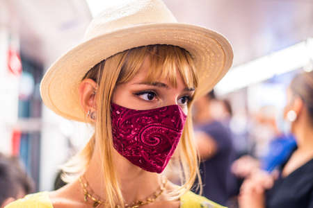 Beautiful girl driving on a subway wagon during covid-19 pandemic, concepts about lifestyle,...