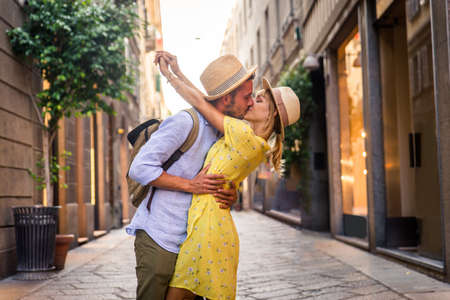 Beautiful couple of lovers shopping in the city center - Playful tourists visiting a famous european cityの写真素材