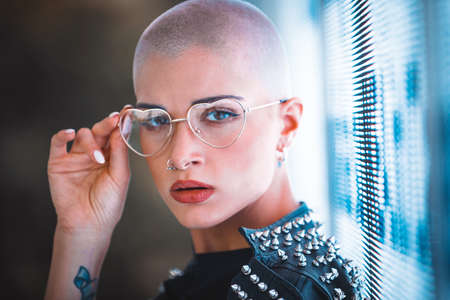 Pretty girl with stylish clothes posing near led lights - Beautiful woman portraitの写真素材