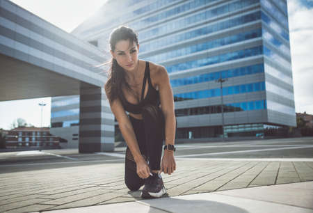 Muslim urban runner training in the city center. Beautiful woman doing sport in the early morning