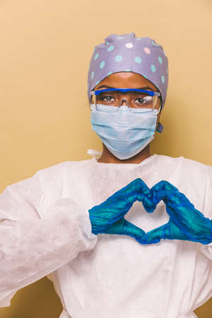 Doctor wearing protection suit and face mask for fighting Covid-19 (Corona virus) - Nurse portrait...