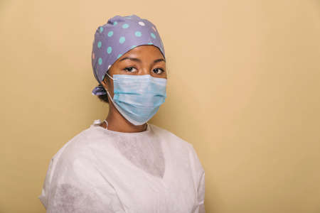 Doctor wearing protection suit and face mask for fighting Covid-19 (Corona virus) - Nurse portrait during coronavirus pandemic quarantine, concepts about healthcare and medicalの写真素材