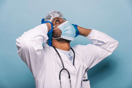 Doctor wearing protection suit and face mask for fighting Covid-19 (Corona virus) - Nurse portrait...