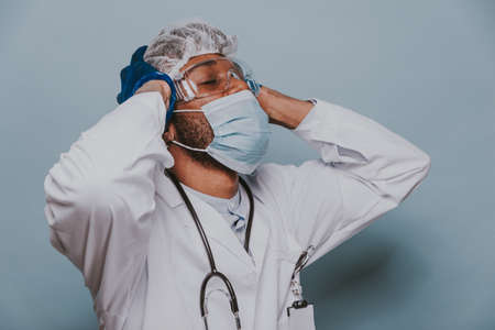 Doctor wearing protection suit and face mask for fighting Covid-19 (Corona virus) - Nurse portrait during coronavirus pandemic quarantine, concepts about healthcare and medicalの写真素材