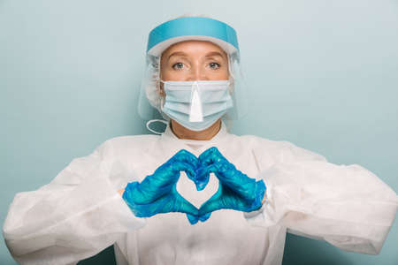 Doctor wearing protection suit and face mask for fighting Covid-19 (Corona virus) - Nurse portrait...