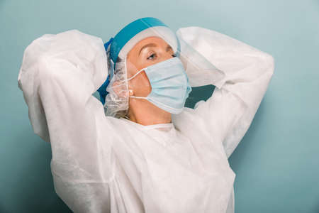 Doctor wearing protection suit and face mask for fighting Covid-19 (Corona virus) - Nurse portrait...