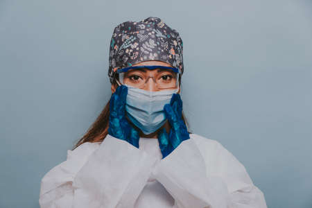 Doctor wearing protection suit and face mask for fighting Covid-19 (Corona virus) - Nurse portrait during coronavirus pandemic quarantine, concepts about healthcare and medicalの写真素材