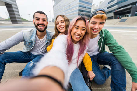 Happy young people meeting outdoors - Group of cheerful teenagers having fun, concepts about teenage, lifestyle and generation zの写真素材