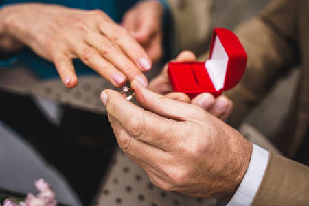 Beautiful senior couple dating outdoors - Mature couple celebrating marrige proposal, concepts about elderly and lifestyleの写真素材