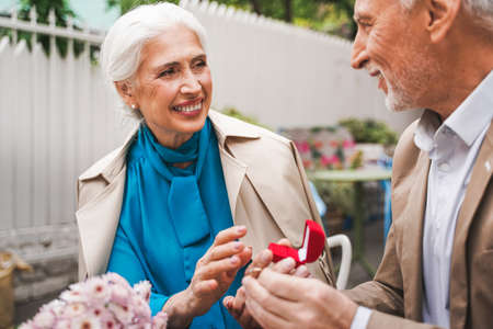Beautiful senior couple dating outdoors - Mature couple celebrating marrige proposal, concepts about elderly and lifestyleの写真素材