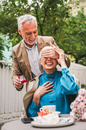 Beautiful senior couple dating outdoors - Mature couple celebrating marrige proposal, concepts about elderly and lifestyleの写真素材