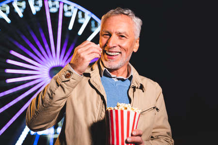 Handsome senior man having fun at amusement park, concepts about elderly and lifestyleの写真素材