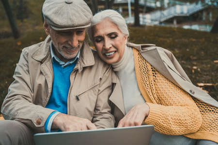 Seniors talking with their relatives through a video chat on the computerの写真素材