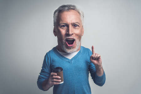 Handsome senior man isolated on gray background. Concept about the third age and seniorityの写真素材