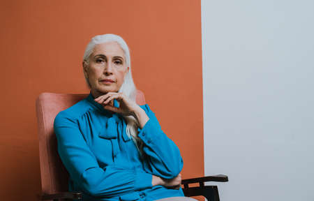 Beautiful senior woman posing on a photoshooting. Concept about lifestyle and seniorityの写真素材