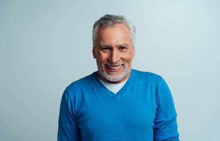 Handsome senior man isolated on gray background. Concept about the third age and seniority