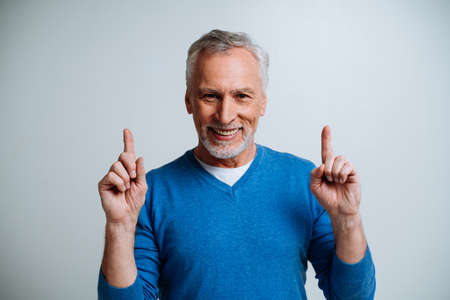 Handsome senior man isolated on gray background. Concept about the third age and seniority
