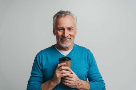 Handsome senior man isolated on gray background. Concept about the third age and seniority
