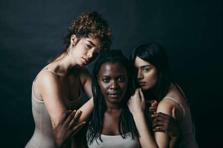 Three girls from different ethnicity posing in the studio for a "body positivity" photo sessionの写真素材
