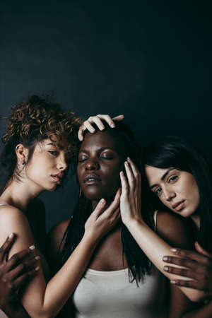 Three girls from different ethnicity posing in the studio for a "body positivity" photo sessionの写真素材