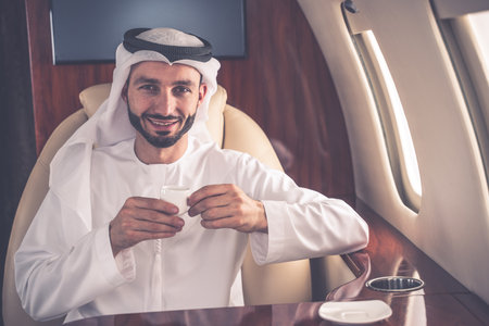 Business man from united arab emirates flying on his private jet to Dubaiの写真素材