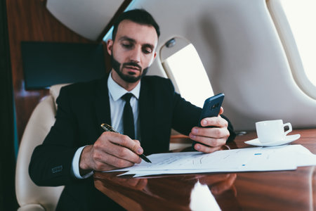 Businessman flying on his private jet. Concept about business, and transportationの写真素材