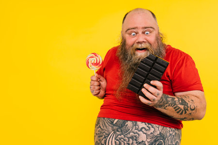 Man eating a chocolate tablet. Concept about food and lifestyleの写真素材