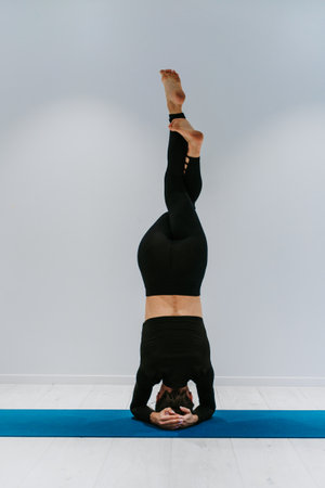 Beautiful girl training in the gym. Russian classic dancer doing stretching and yoga posesの写真素材