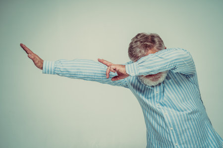 Funny senior man posing in a photoshooting. Happy hipster doing funny expressions. Concept about people and lifestyle.の写真素材