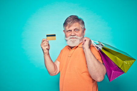 Funny senior man posing in a photoshooting. Happy hipster doing funny expressions. Concept about people and lifestyle.の写真素材