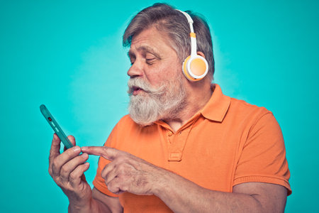 Funny senior man posing in a photoshooting. Happy hipster doing funny expressions. Concept about people and lifestyle.の写真素材