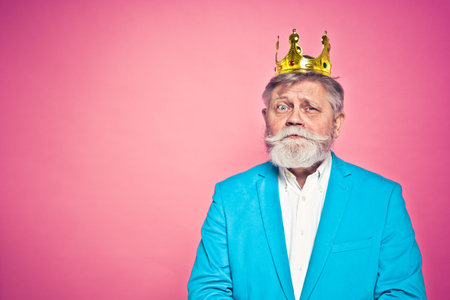 Funny senior man posing in a photoshooting. Happy hipster doing funny expressions. Concept about people and lifestyle.の写真素材