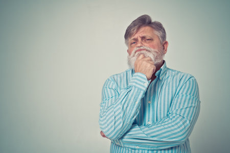 Funny senior man posing in a photoshooting. Happy hipster doing funny expressions. Concept about...