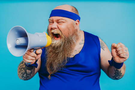 Funny fat man doing some sport exercises - Overweight man having weight issue and tries to start diet and sport, funny characterの写真素材