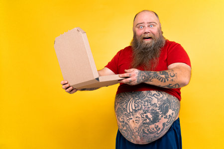 Funny and hilarious fat man hungry for unhealthy food