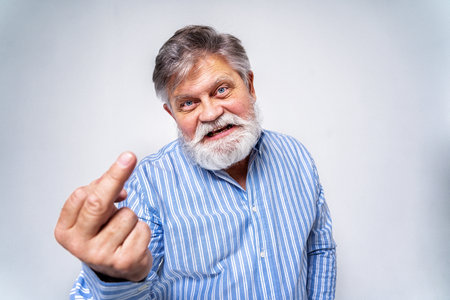 Eccentric senior man with funny expression portrait on background - Active and youthful old maleの写真素材