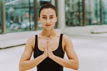 Beautiful athletic woman training in a gym, doing stretching exercises before the workout - Pretty young girl training aloneの写真素材