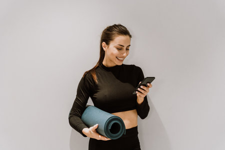 Beautiful athletic woman training in a gym, doing stretching exercises before the workout - Pretty...