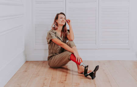 Beautiful young woman with amputation - Pretty and confident woman with leg disability, amputee posing against body shamingの写真素材